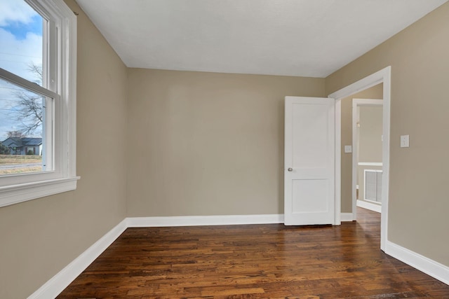 empty room with dark wood-type flooring