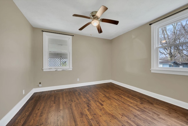 unfurnished room featuring dark hardwood / wood-style flooring and ceiling fan