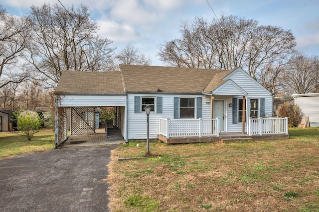 view of front facade with a carport and a front yard