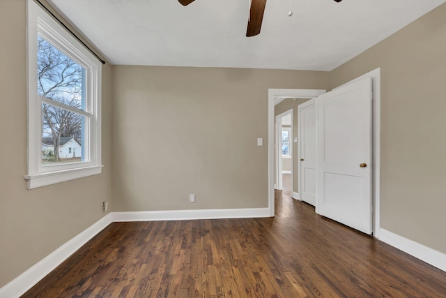 unfurnished room featuring dark hardwood / wood-style floors and ceiling fan