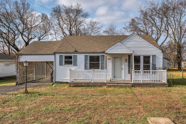 view of front of property with a front yard and a carport