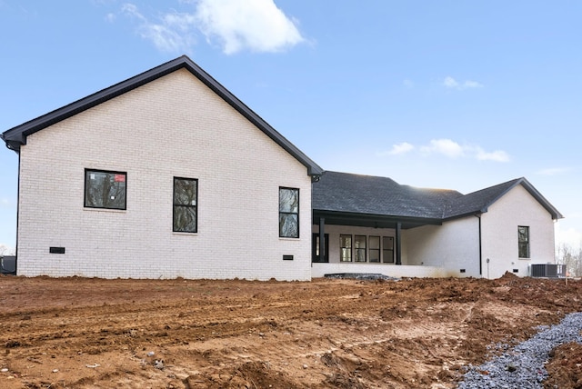 rear view of property featuring central air condition unit