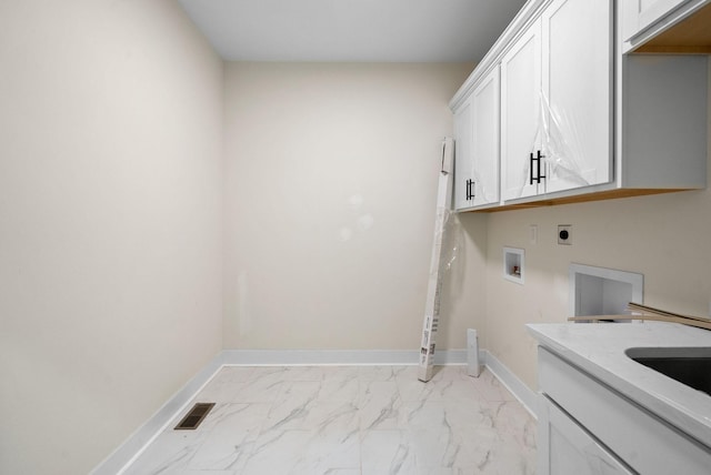 washroom featuring electric dryer hookup, cabinets, and washer hookup