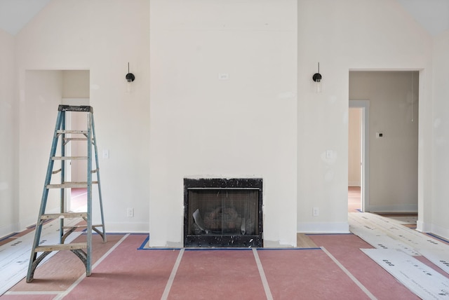 unfurnished living room with carpet flooring and high vaulted ceiling