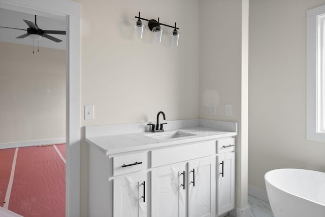 bathroom featuring vanity, ceiling fan, and a tub