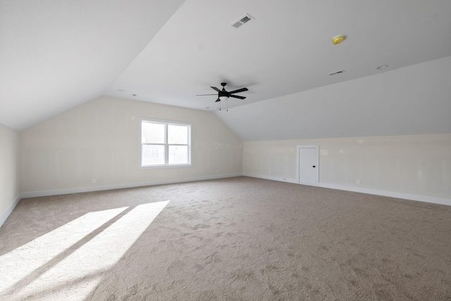 additional living space with light carpet, ceiling fan, and lofted ceiling