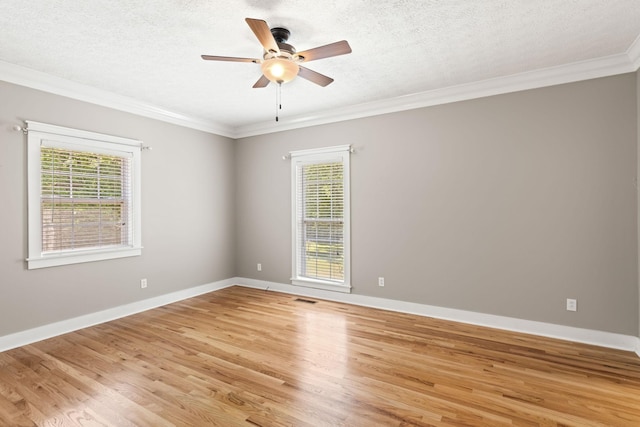 spare room featuring a textured ceiling, light wood-type flooring, ceiling fan, and ornamental molding