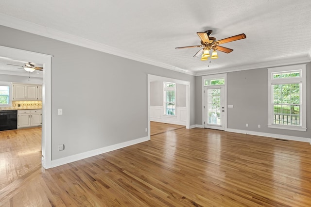 unfurnished living room with a textured ceiling, light wood-type flooring, ceiling fan, and crown molding