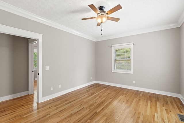 empty room with a textured ceiling, ceiling fan, light wood-type flooring, and ornamental molding