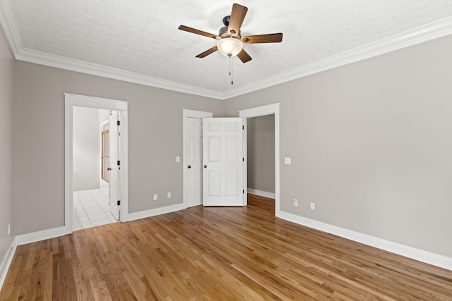 unfurnished bedroom featuring ceiling fan, ornamental molding, a textured ceiling, and light hardwood / wood-style flooring