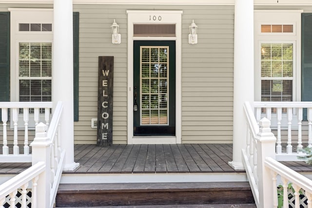 view of exterior entry with a porch