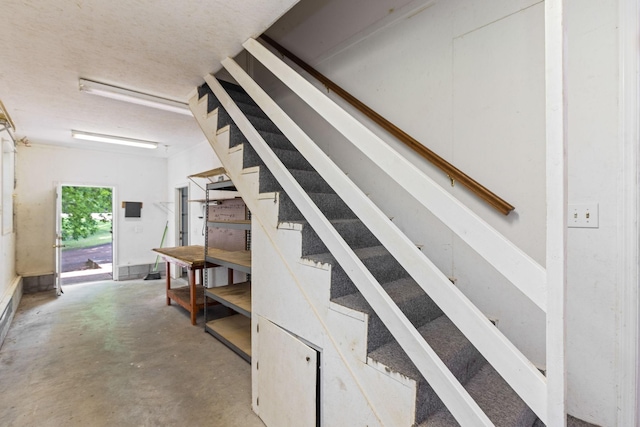 staircase with concrete flooring