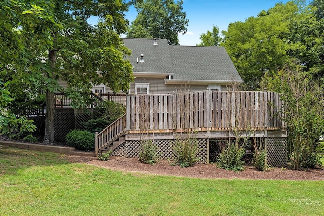 back of property featuring a lawn and a deck