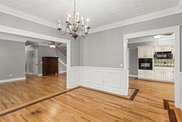 unfurnished dining area with a textured ceiling and light wood-type flooring