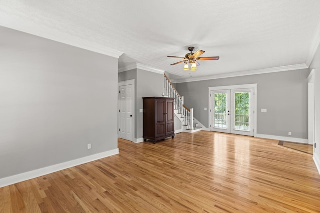 unfurnished living room featuring french doors, ceiling fan, ornamental molding, a textured ceiling, and light hardwood / wood-style floors