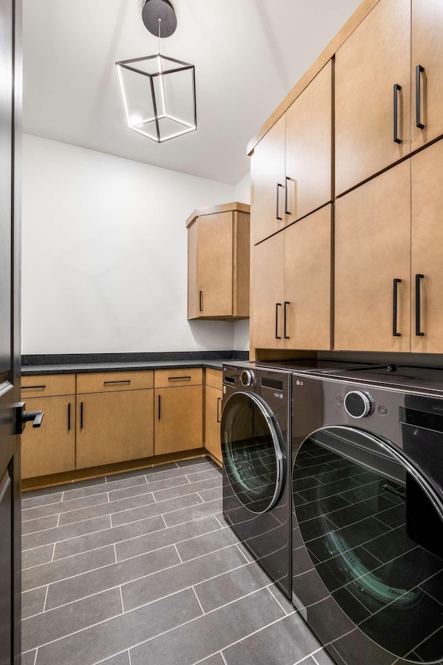 laundry room with cabinets and washer and dryer