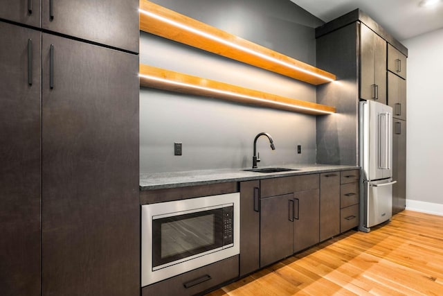 kitchen featuring sink, stainless steel appliances, and light hardwood / wood-style floors