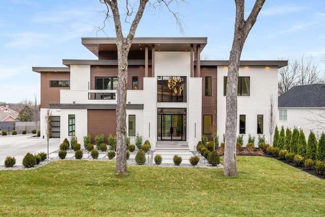 contemporary home featuring a front lawn