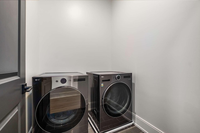 laundry area with tile patterned floors and washing machine and dryer