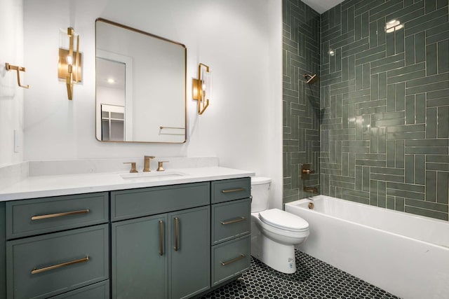 full bathroom with tile patterned flooring, vanity, tiled shower / bath combo, and toilet