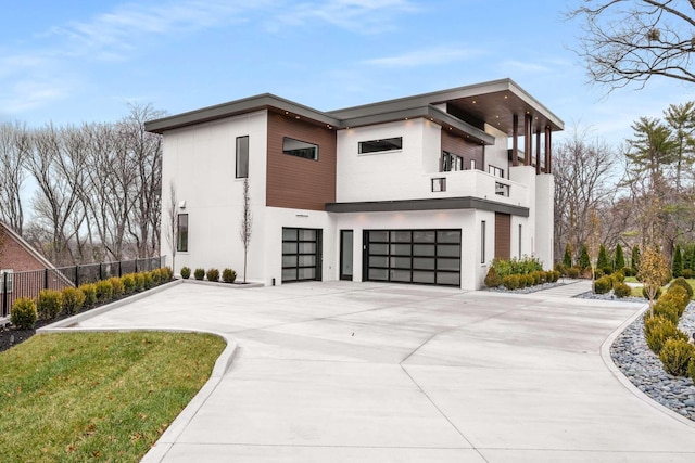 view of front facade with a garage and a balcony