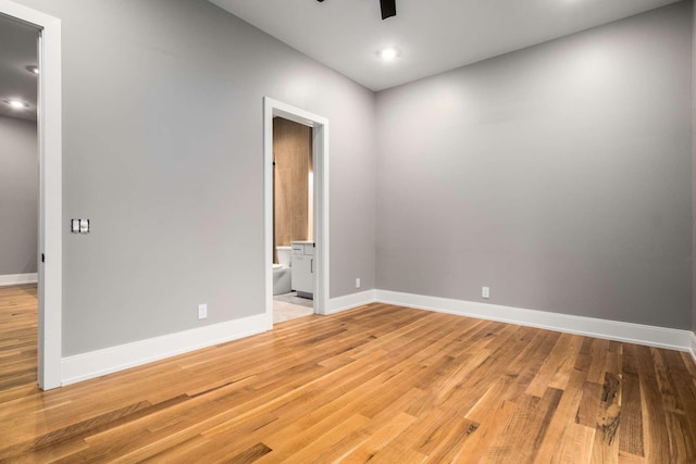 empty room featuring ceiling fan and light hardwood / wood-style flooring