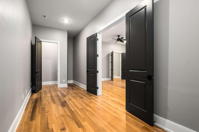 hallway with light wood-type flooring