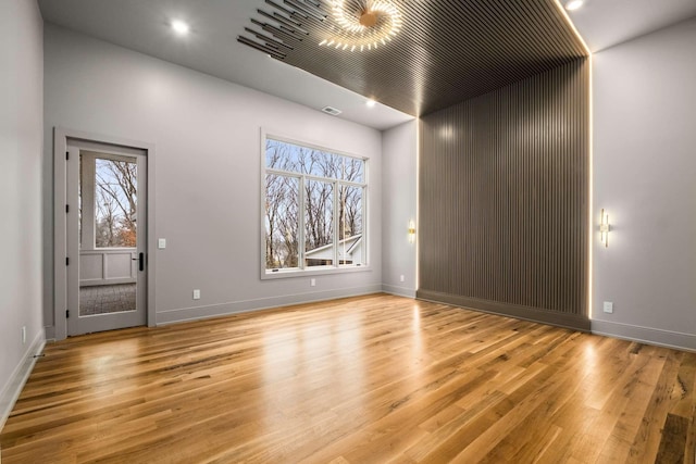 unfurnished room featuring light hardwood / wood-style floors and a healthy amount of sunlight