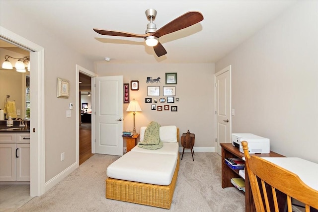 sitting room with ceiling fan, sink, and light carpet