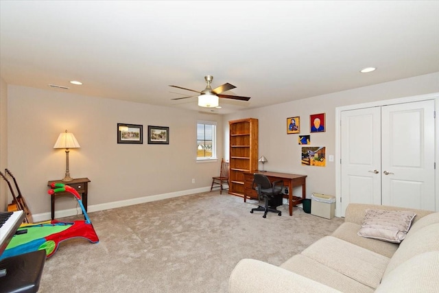 office space with light carpet and ceiling fan