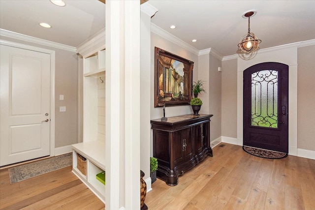 entrance foyer featuring light hardwood / wood-style flooring and crown molding