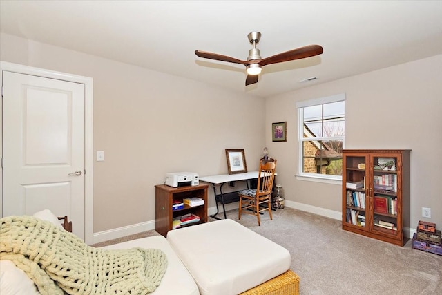 carpeted home office with ceiling fan