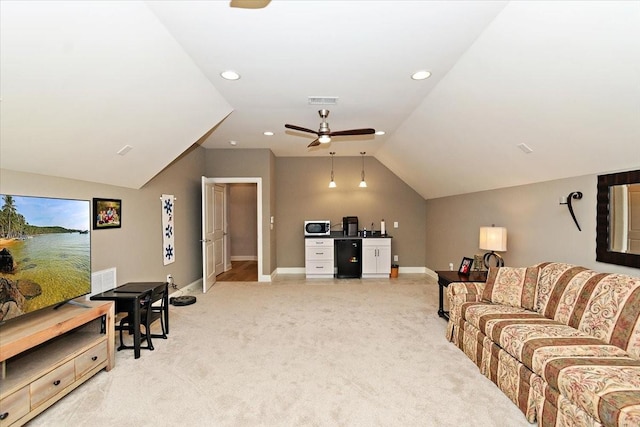 carpeted living room featuring ceiling fan and vaulted ceiling