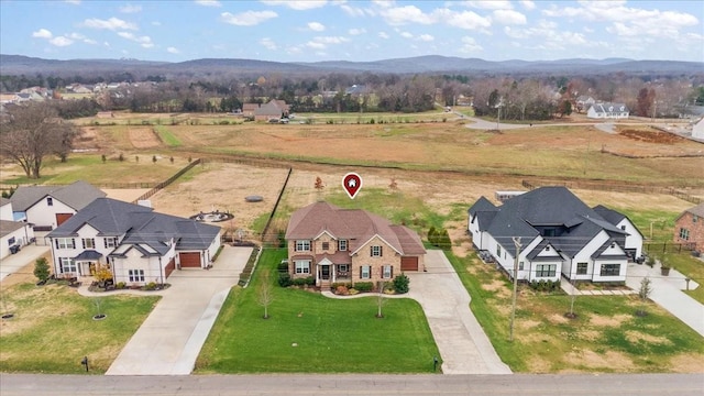 birds eye view of property with a mountain view