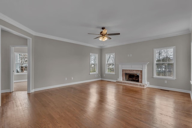 unfurnished living room with ceiling fan, light hardwood / wood-style floors, ornamental molding, and a fireplace