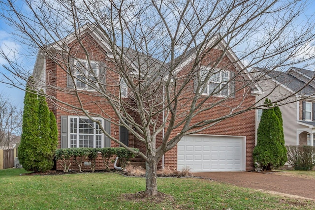 view of front of property with a front yard and a garage