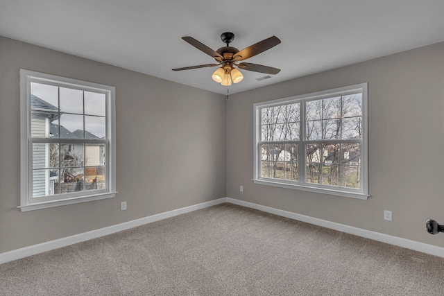 carpeted spare room with ceiling fan