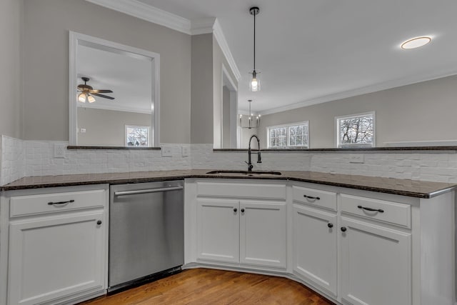 kitchen with white cabinets, pendant lighting, stainless steel dishwasher, and sink