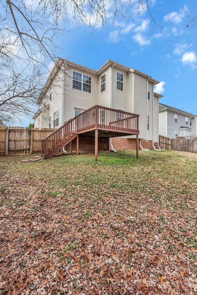 back of property featuring a yard and a deck