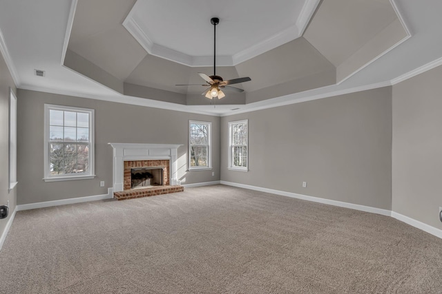 unfurnished living room featuring ornamental molding and a tray ceiling