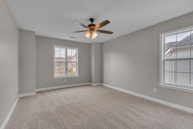 carpeted empty room featuring ceiling fan