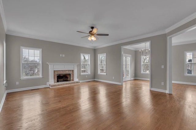 unfurnished living room with plenty of natural light, light hardwood / wood-style floors, and ornamental molding