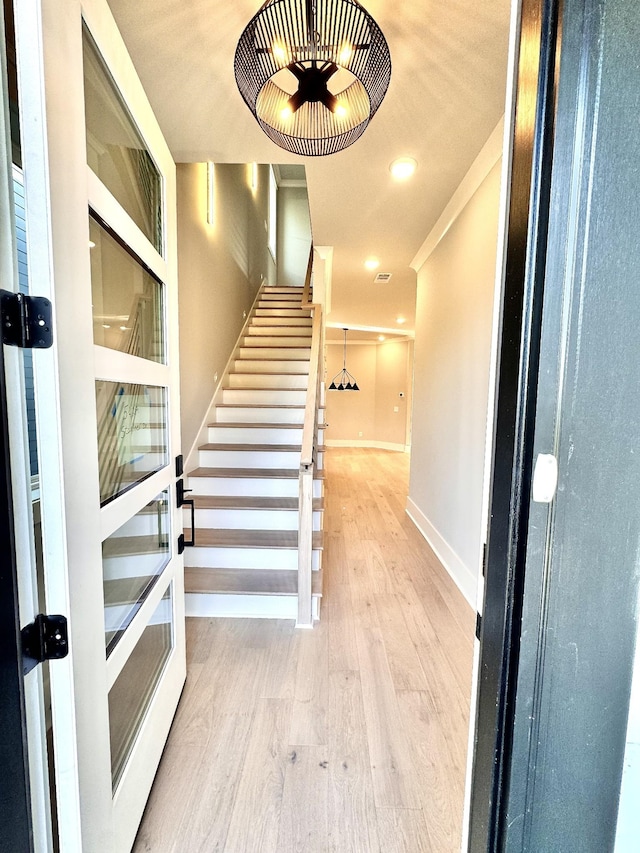 stairs with hardwood / wood-style floors