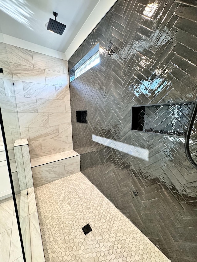 bathroom with tiled shower