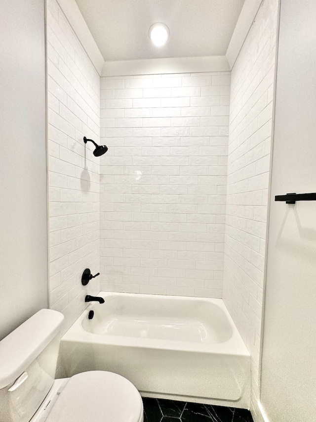 bathroom with tiled shower / bath, toilet, and tile patterned flooring