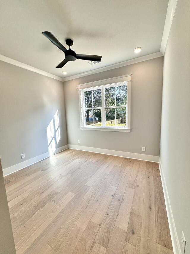 empty room with crown molding, ceiling fan, and light wood-type flooring