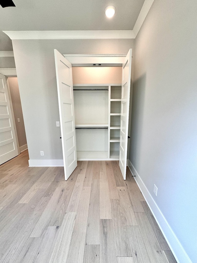 unfurnished bedroom featuring a closet and light wood-type flooring