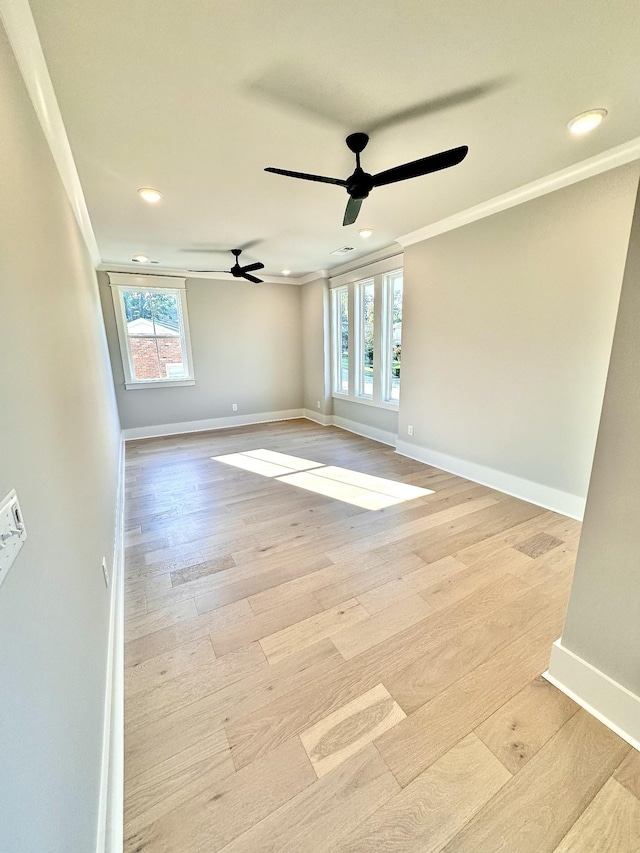 unfurnished room featuring ornamental molding, ceiling fan, and light hardwood / wood-style floors