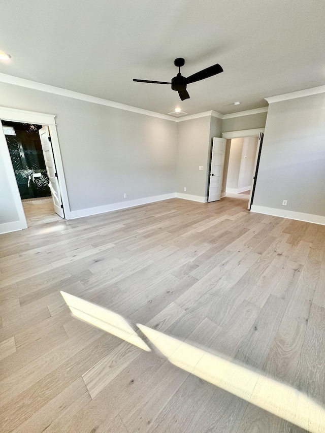 unfurnished room with crown molding, ceiling fan, and light hardwood / wood-style flooring