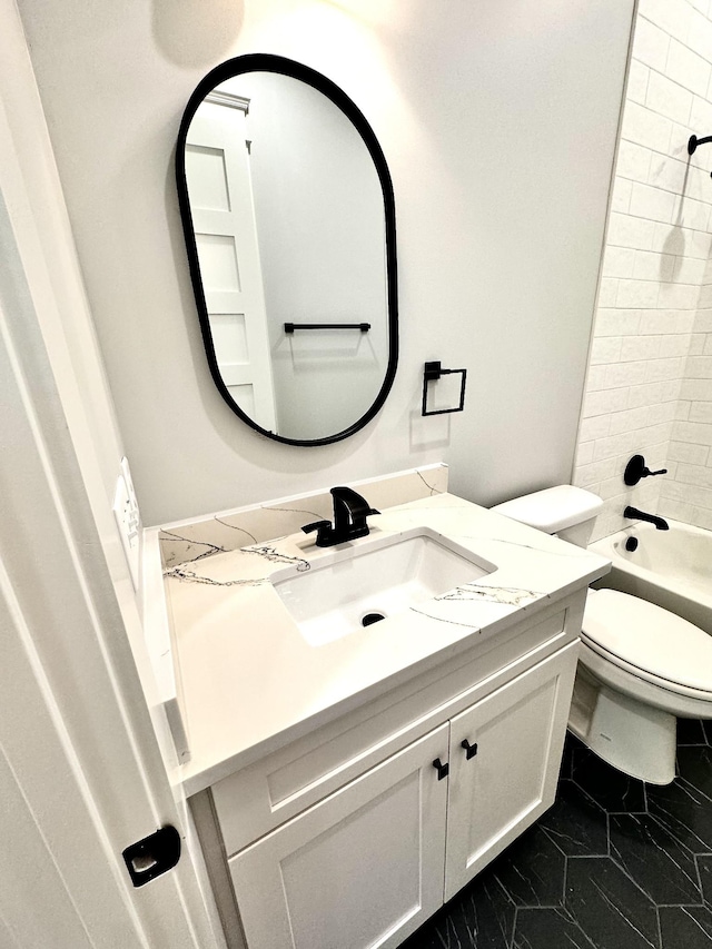 full bathroom featuring vanity, tiled shower / bath combo, and toilet